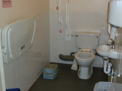 Disabled toilet with a baby changing facility.