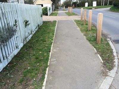 THE NEW TAYLOR WOODROW FOOTPATH WITH CAR PARKING RESTRICTION POSTS IN PLACE.
